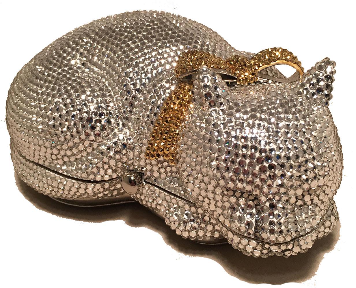 ADORABLE Vintage Judith Leiber cat minaudiere in excellent condition. Clear Swarovski crystal body with a gold crystal bow tie at neck. Silver leather exterior base. Button closure opens to a silver leather lined interior. Excellent condition, no