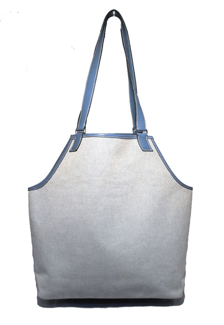 RARE & Amazing HERMES canvas and leather shoulder bag tote in excellent condition.  Beige woven canvas toile exterior trimmed with light blue clemence leather and silver hardware.  One front slit leather pocket on the front exterior side of this