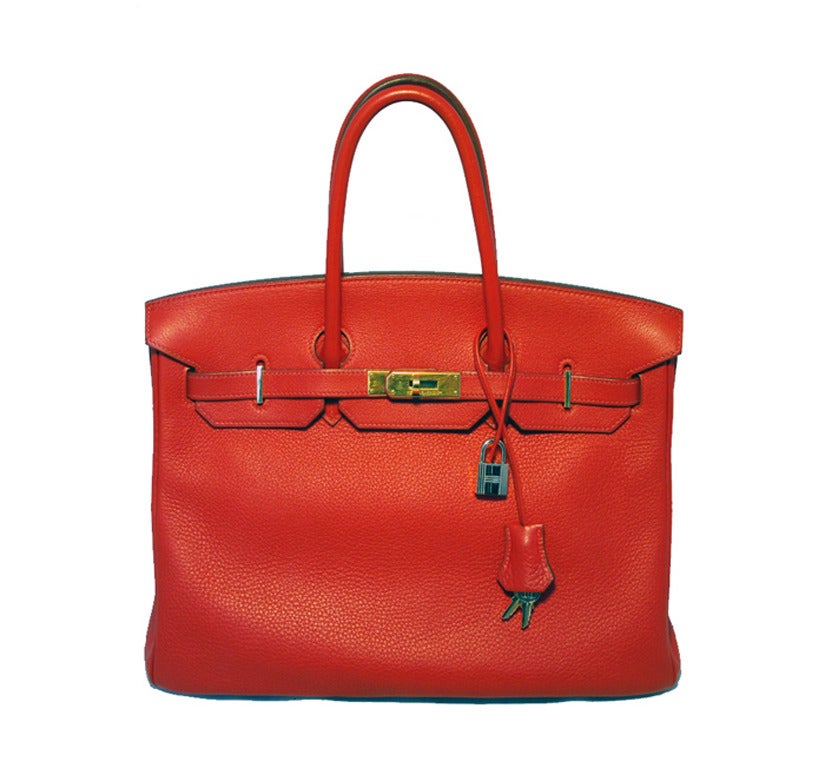 Stunning Hermes 35cm birkin in rare Rouge Vif clemence leather. Beautiful red clemence exterior trimmed with shining gold hardware.  Signature Birkin double strap twist closure opens to a matching red leather interior that holds 1 zippered & 1 slit