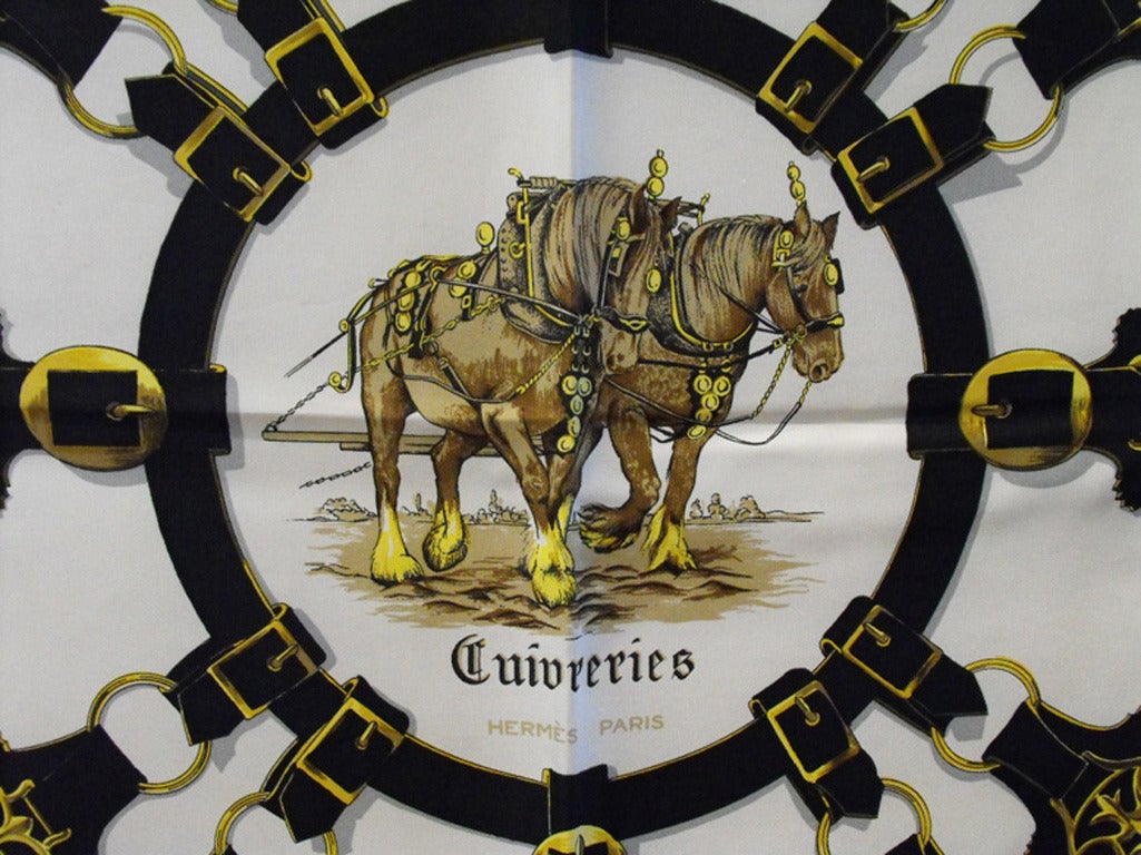 AUTHENTIC HERMES CUIVRERIES vintage silk scarf in excellent condition. Original silk screen design c1963 by Françoise De La Perriere features a beautiful array of equestrian style buckles and harness trimmings in red, black, white and gold.  100%