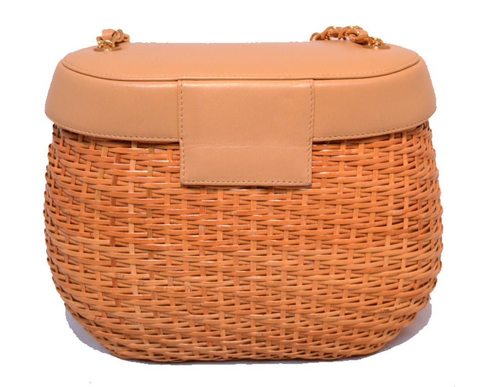 Fabulous Chanel tan leather and wicker shoulder bag in excellent condition. Tan leather with wicker basket shape trimmed with gold hardware. Signature CC logo twist closure opens to a tan leather lined interior that holds 1 slit and 1 zippered side