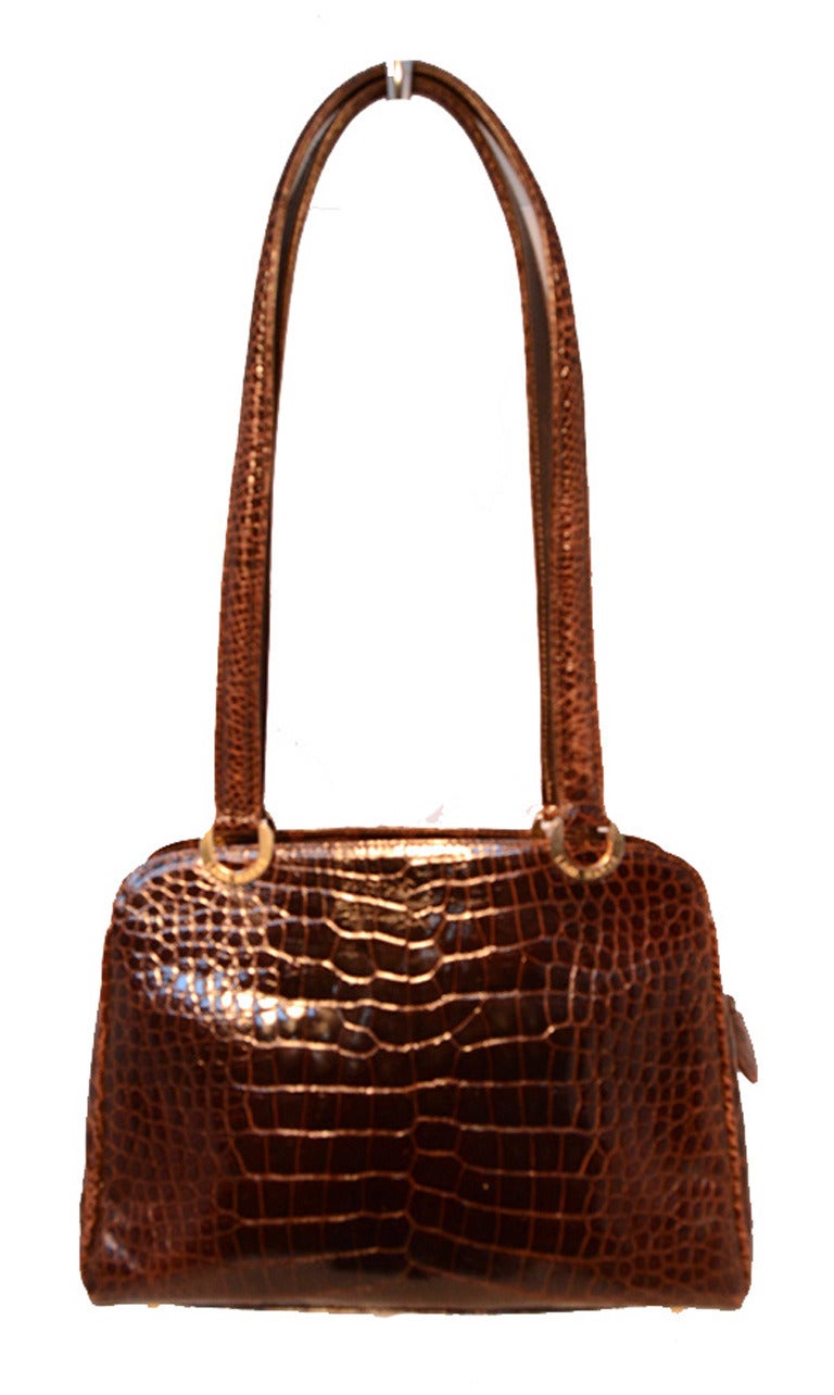 BEAUTIFUL LANA MARKS brown alligator shoulder bag in excellent condition.  Brown alligator leather exterior trimmed with shining gold hardware.  Two exterior side slit pockets for added storage.  Double shoulder handle straps for easy, comfortable