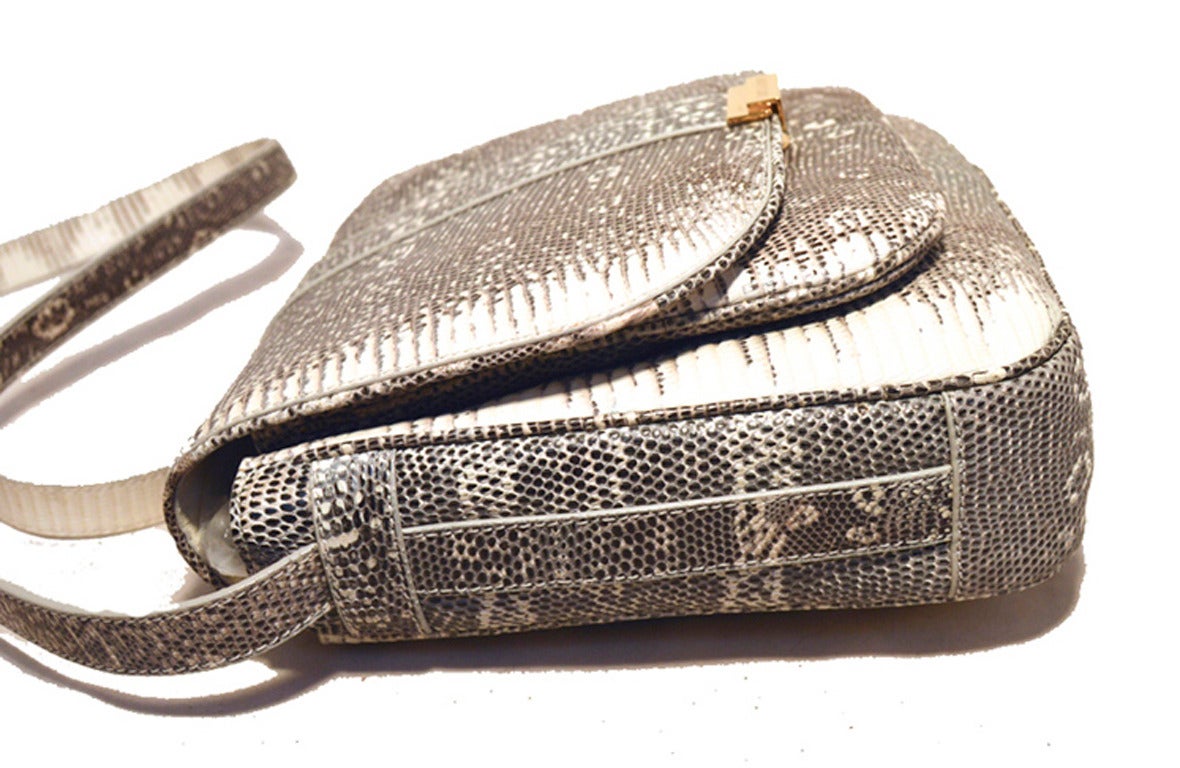 Fabulous TRUSSARDI grey and white ring lizard shoulder bag in excellent condition.  Natural grey and white ring lizard exterior trimmed with gold hardware.  Single flap style closure opens to a tan nylon lined interior with 2 separate storage
