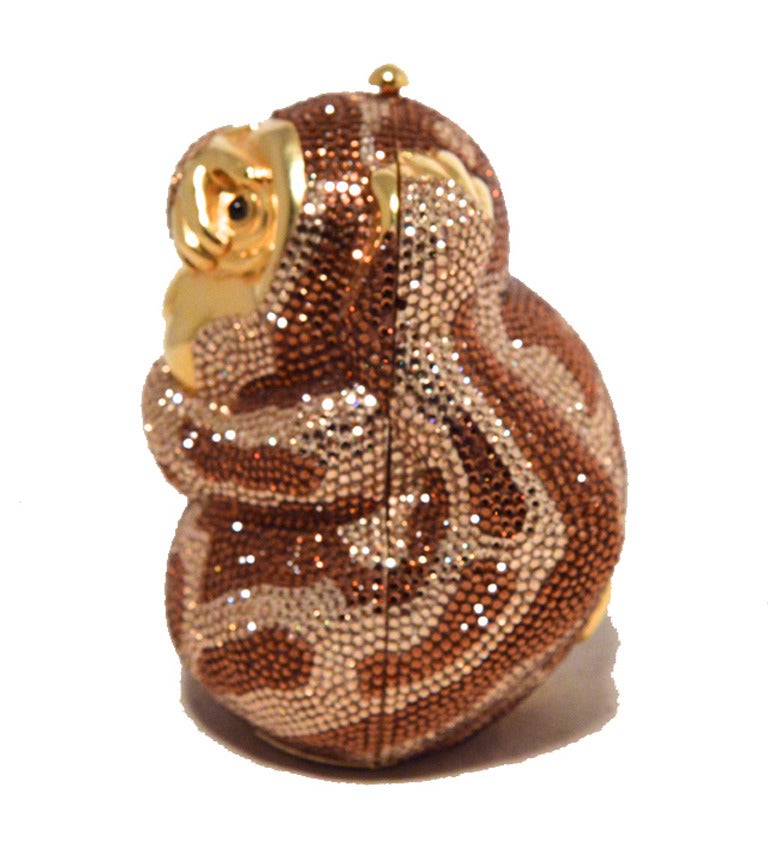 STUNNING JUDITH LEIBER hiding monkey minaudiere in excellent condition.  Swarovksi crystal exterior in an adorable monkey form with gold hardware trim.  Top push button closure opens to a gold leather lined interior that holds a hidden attached gold