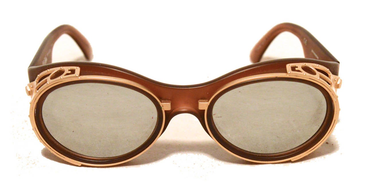 Very Unique Jean Paul Gaultier vintage sunglasses in excellent condition.  Brown matte body with matte gold hardware trim.  Silver mirrored lenses with UV protection. Made in France. No scuffs or scratches. Absolutely beautiful condition.  Perfect