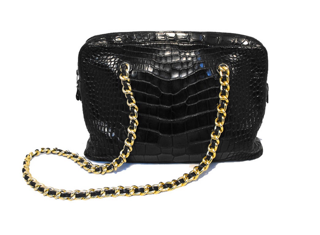 Fabulous Judith Lieber Black alligator shoulder bag in excellent condition.  Black alligator leather exterior trimmed with a double gold chain shoulder strap. Top zipper closure opens to a black leather lined interior that holds 1 slit and 1