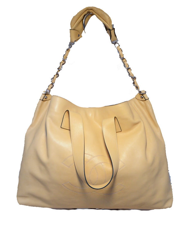 RESERVED LISTING Chanel Buttery Beige Lambskin Weekend Shoulder Bag Tote in excellent contidition.  Soft beige lambskin leather exterior trimmed with silver hardware and CC logo stitched along the front side.  Double leather handle straps and an