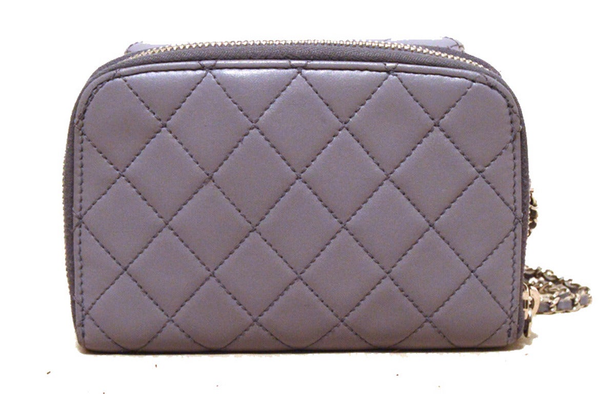 SUPERB AUTHENTIC CHANEL lilac leather Wallet on a chain in excellent condition.  Lilac quilted lambskin leather exterior trimmed with silver hardware.  Front pouch pocket with twist CC closure and lilac satin lined interior.  Back zippered pocket is