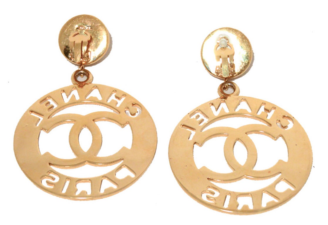 RARE-AUTHENTIC-VINTAGE CHANEL earrings in excellent condition.  Gold lazer cut round emblems with the CC Chanel logo and Chanel Paris topped with large round white pearl stones.  Clasp back closures make for easy and comfortable wear. Excellent