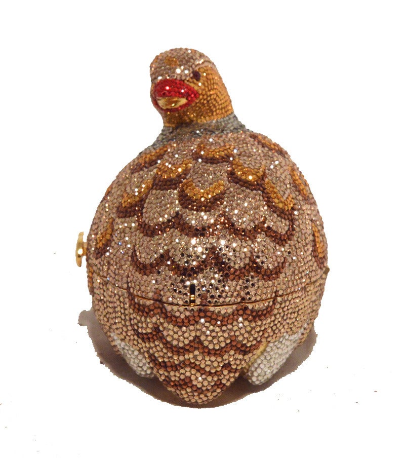 RARE Judith Leiber Swarovski crystal partridge minaudiere in excellent condition.  Multicolored swarovski crystal exterior in a fabulous partridge bird shape.  Front sliding style closure opens to a gold leather lined interior that holds 1 side slit