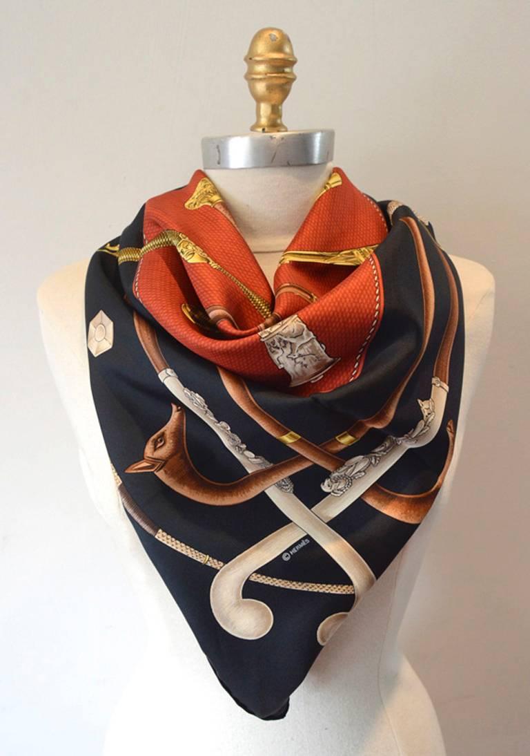 AUTHENTIC HERMES Cannes et Pommeaux silk scarf in excellent condition.  Original silk screen design c1985 by Françoise De La Perriere features an assortment of walking canes over a dark background. 100% silk, hand rolled hem, made in france.