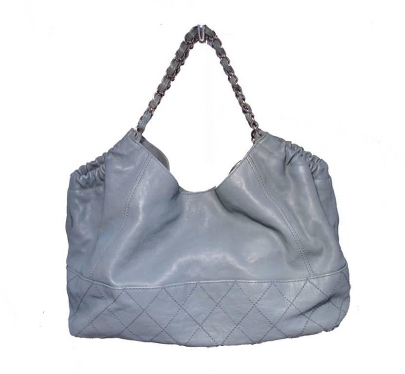 UTHENTIC CHANEL robins egg blue leather shopper shoulder tote in very good condition.  Blue lambskin leather exterior trimmed with silver hardware.  Signature woven leather and chain shoulder straps.  Elastic sides.  Magnetic snap closure opens to a