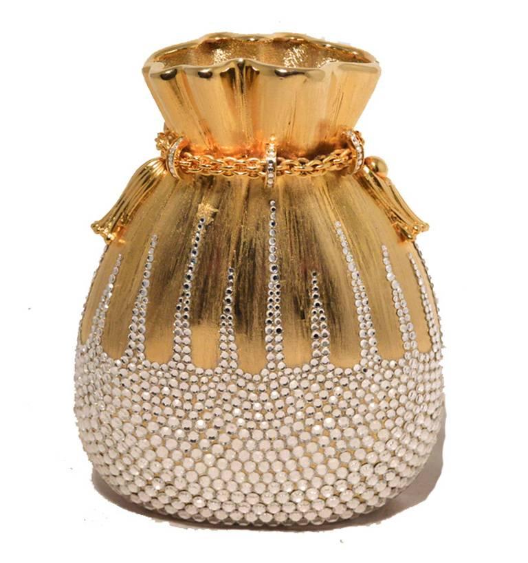 Stunning Judith Leiber swarovski crystal beggars bag minaudiere in excellent condition.  Gold exterior covered with clear swarovski crystals. Push button side closure opens to a gold leather lined interior that holds a hidden gold chain shoulder