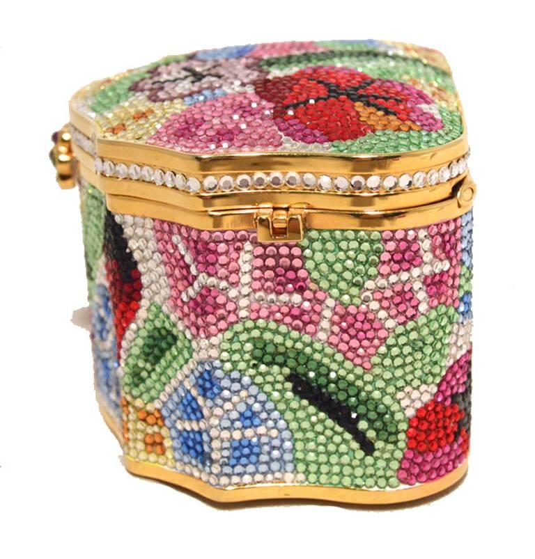 AMAZING JUDITH LEIBER floral jewelry box minaudiere in excellent condition.  Multi-colored swarovski crystal exterior in a stunning floral arrangement.  Front lifting closure opens to a gold leather lined interior that holds an attached gold chain