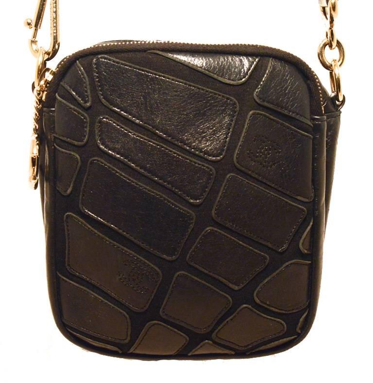 Stunning CHANEL black leather crossbody bag in excellent condition.  Black leather exterior in a unique patchwork design trimmed with shining silver hardware.  Full zipper detail along the length of the strap. Top double zipper opens 2 separate