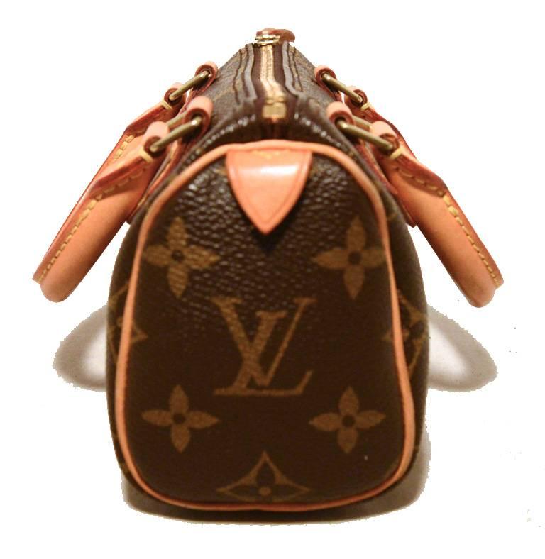 ADORABLE Louis Vuitton nano speedy in excellent condition.  Monogram canvas with tan leather trim and brass hardware.  Top zipper closure opens to a brown unlined canvas interior that holds just the right amount of storage space. Removable leather