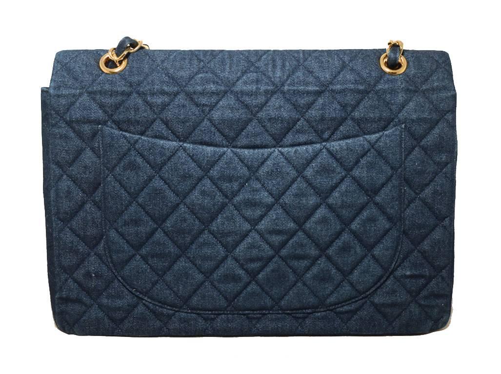 GORGEOUS CHANEL denim maxi flap bag in excellent condition.  Quilted denim exterior trimmed with gold hardware.   Signature CC logo twist closure opens single flap style to a black leather lined interior that holds 1 slit and 1 zippered side
