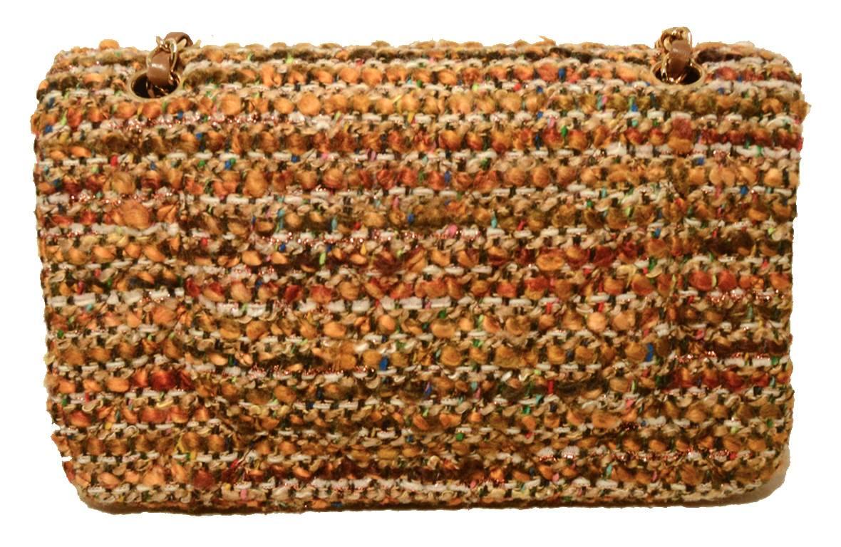 FABULOUS CHANEL tweed 2.55 double flap classic in excellent condition.  Woven multicolor tan, brown, caramel tweed exterior trimmed with woven chain and leather shoulder strap and shining gold hardware.  Signature twist CC logo closure opens double