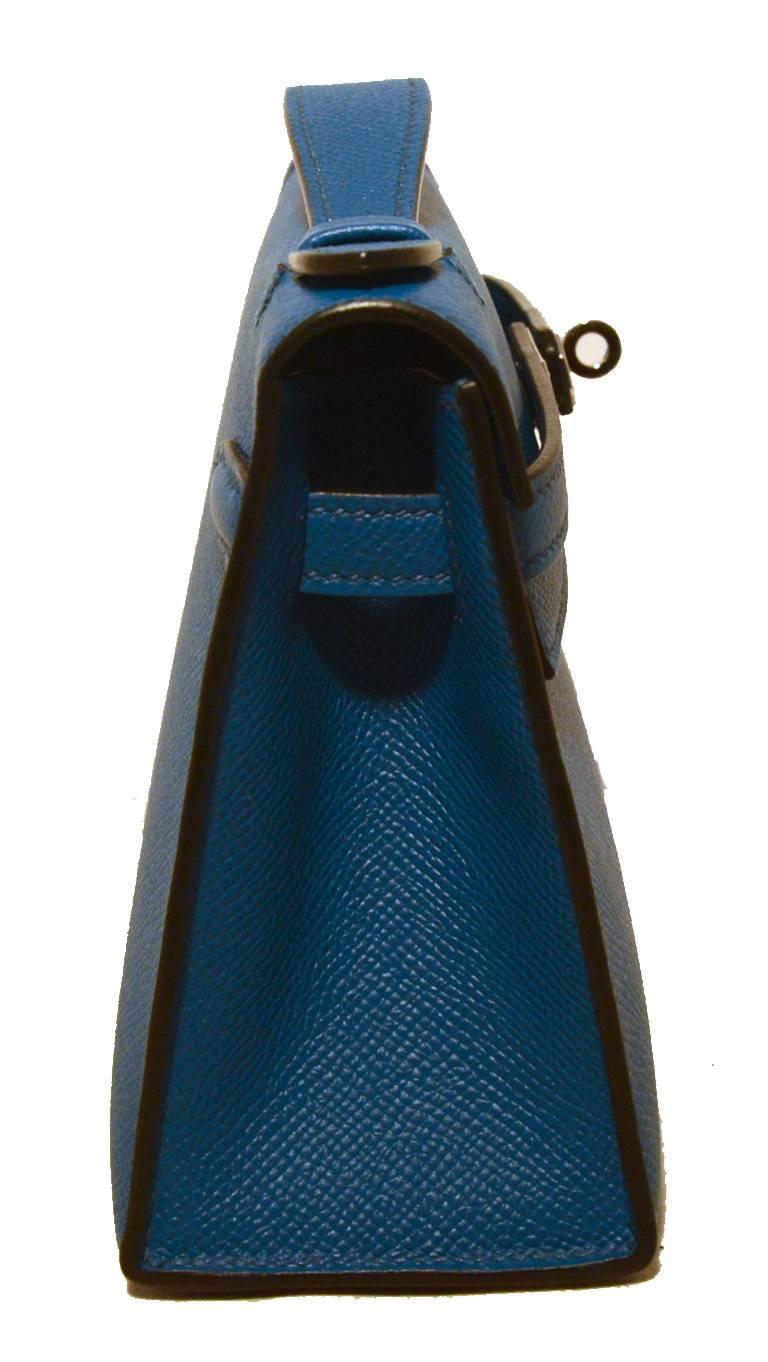 STUNNING HERMES blue kelly pochette clutch bag in excellent condition.  Izmir blue epsom leather exterior with silver palladium hardware.  Signature twisting double strap kelly closure opens to a matching blue leather lined interior that holds one