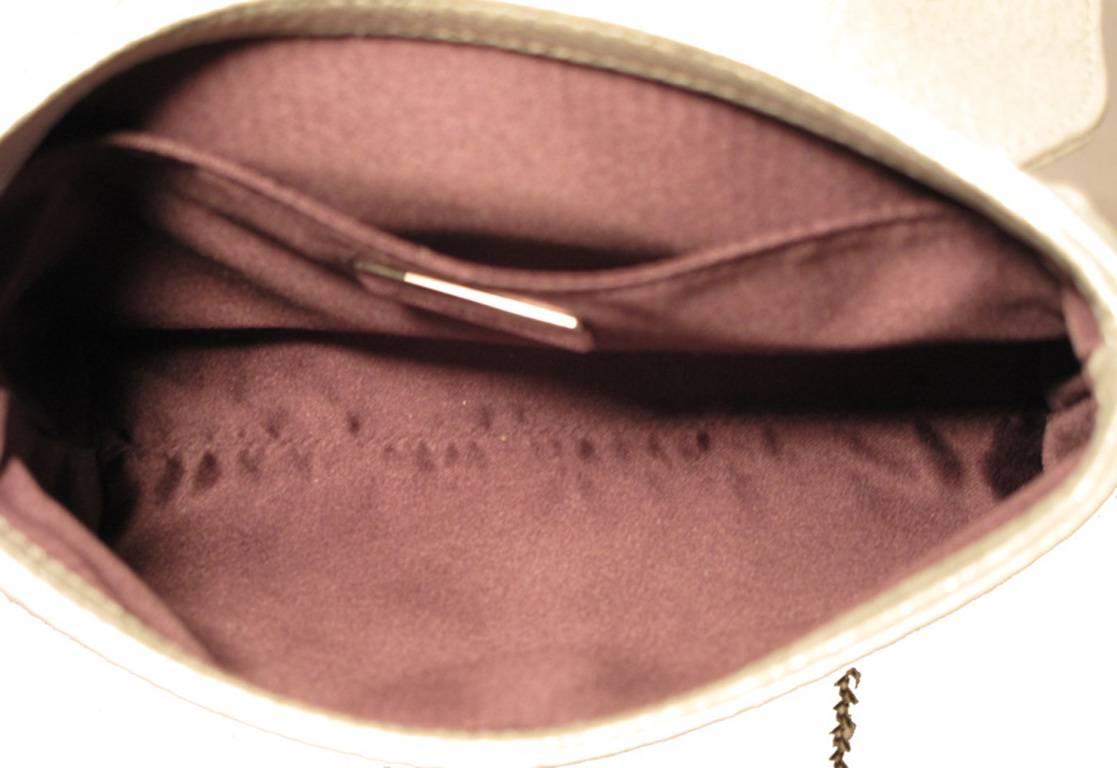 Gorgeous Judith Leiber shimmery leather embellished evening bag in Excellent condition.  Soft, light grey, shimmery leather exterior with a very unique embellishment along the front top flap. Silver hardware, Swarovski crystal, White quartz, Grey
