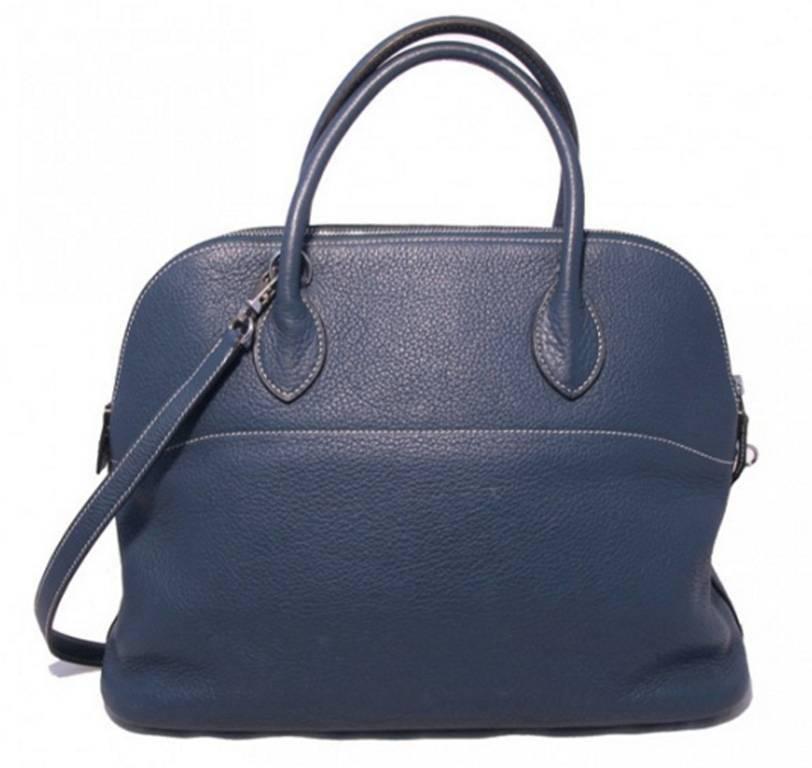 RARE Hermes Blue Clemence leather Bolide in Very Good condition. Exterior features blue clemence leather trimmed with palladium hardware and comes complete with a removable matching leather shoulder strap to easily convert this piece from hand to