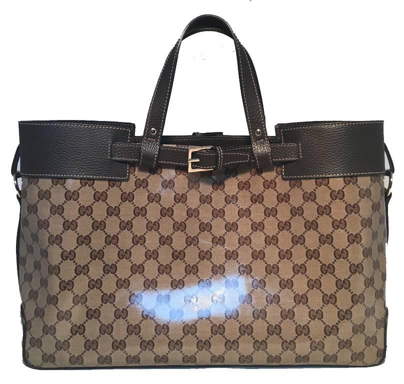 BEAUTIFUL Gucci monogram and leather portfolio tote in excellent condition.  Coated monogram canvas trimmed with dark brown leather and silver hardware.  Buckle details on both exterior top sides.  Brown nylon lined interior with ample storage space