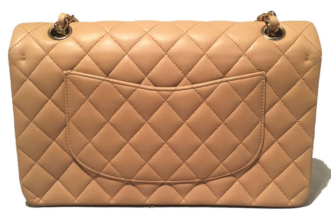 GORGEOUS Chanel nude 2.55 10 inch double flap classic in excellent condition.  Nude lambskin leather exterior trimmed with gold hardware and woven chain and leather shoulder strap. front CC logo closure opens via double flap to matching nude leather