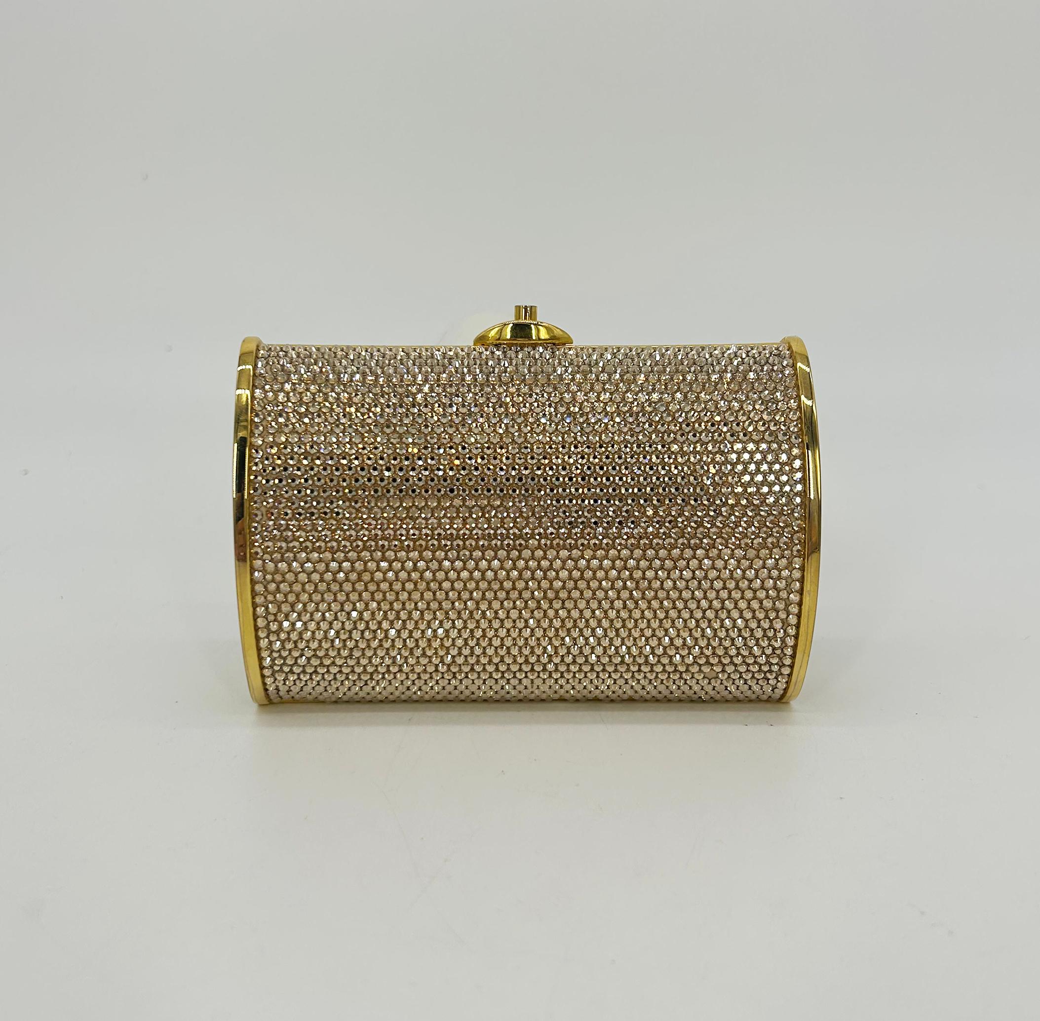 Judith Leiber Gold Swarovski Crystal Mini Minaudiere in excellent condition. Gold swarovski crystals surrounding each exterior side trimmed with gold hardware and edges. Top push button closure opens to a gold leather interior with an attached gold