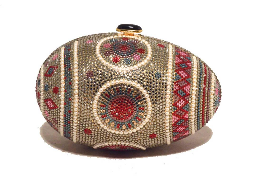 RARE JUDITH LEIBER Swarovski crystal and pearl faberge egg minaudiere in excellent condition.  Multi-color swarovski crystal adorned exterior trimmed with pearls in a beautiful faberge egg design.  Top black button closure opens to a gold leather