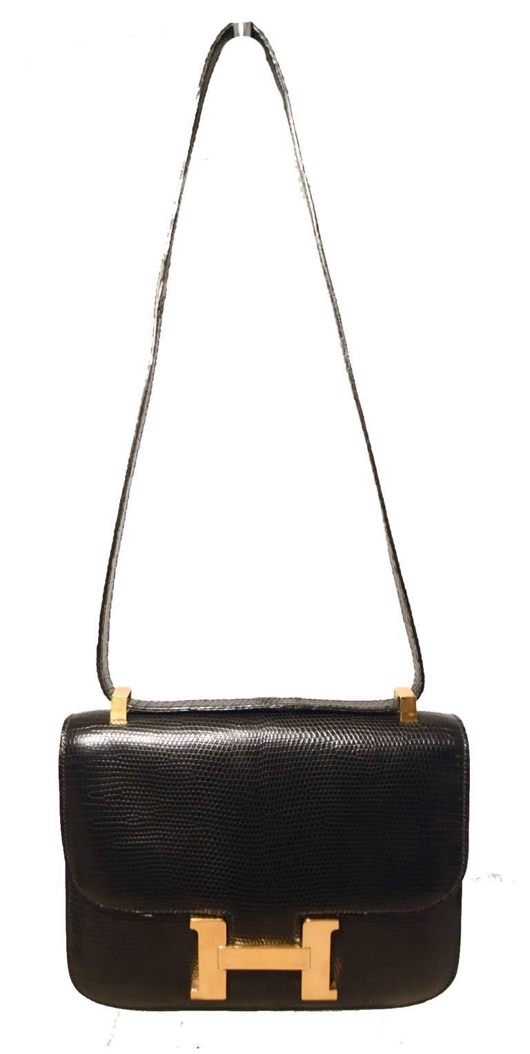 AUTHENTIC HERMES black lizard constance bag in excellent vintage condition.  Black lizard leather exterior trimmed with shining gold hardware.  Lift latch single flap style closure opens to a black leather lined interior that holds 2 slit and 1