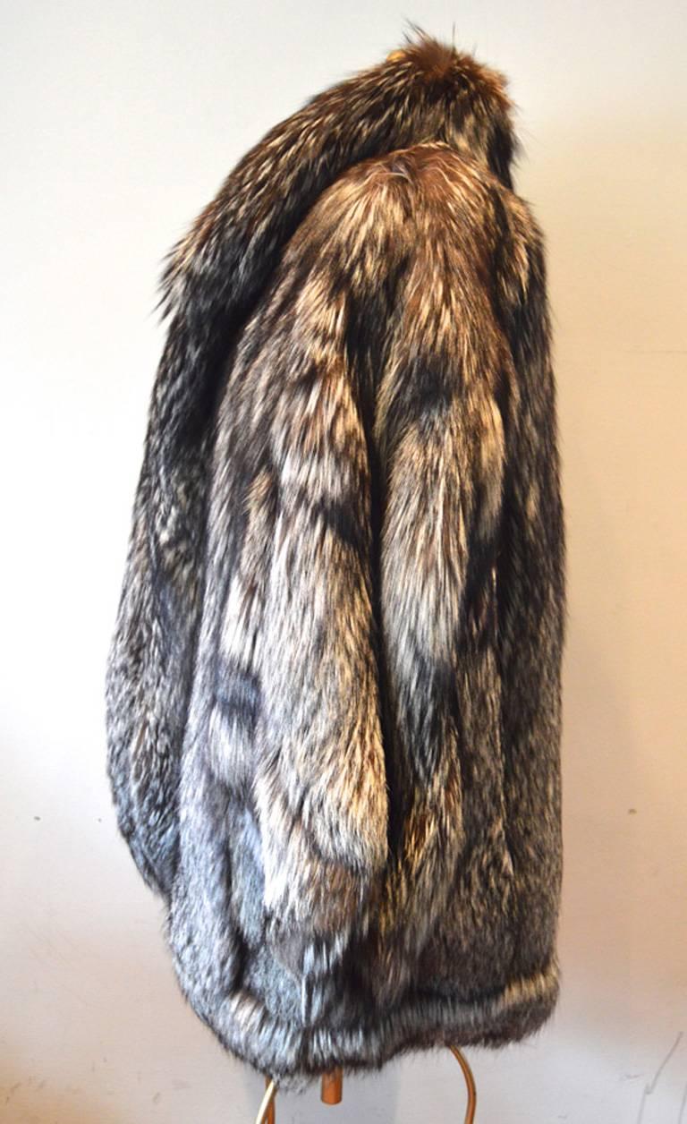 GORGEOUS  silver fox fur coat in excellent condition.  Stunning long haired silver fox fur in grey, white, brown, and natural cream colors.  The silver fox is extremely rare and highly sought after in the fashion world since it's coats are so hard
