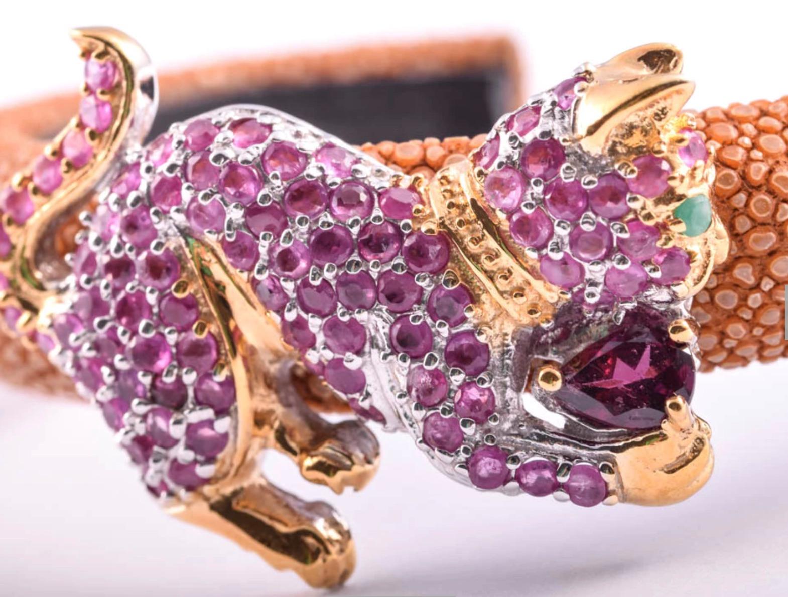 A gorgeous fashion forward Shagreen Cat Cuff Bracelet. Gold over sterling silver laden with Ruby, Garnet, and Emerald Gemstone Cat embellishment.
87 round rubies-2mm 3.50 ctw
Pear Shaped Garnet-7mmx5mm   .84 carat
Emerald-2mm round-  .03