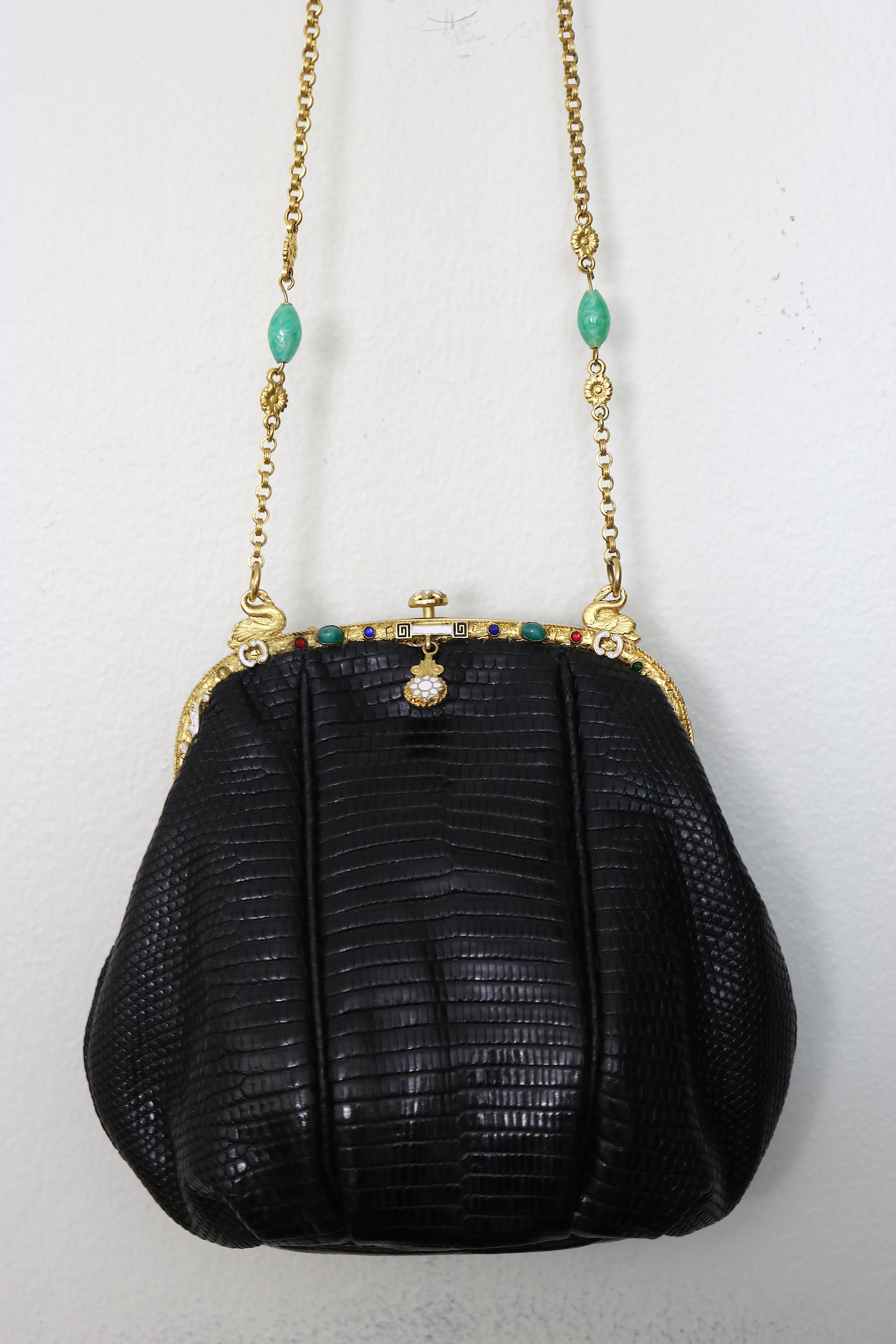 Gorgeous and Rare black lizard Jeweled Evening Bag designed with a circa 1925 24 Karat Gold plate Art Nouveau Frame with a pair of beautiful 24 K gold-plate Swan rings holding the chain on top of the bag. Truly a work of art!

The frame has enamel