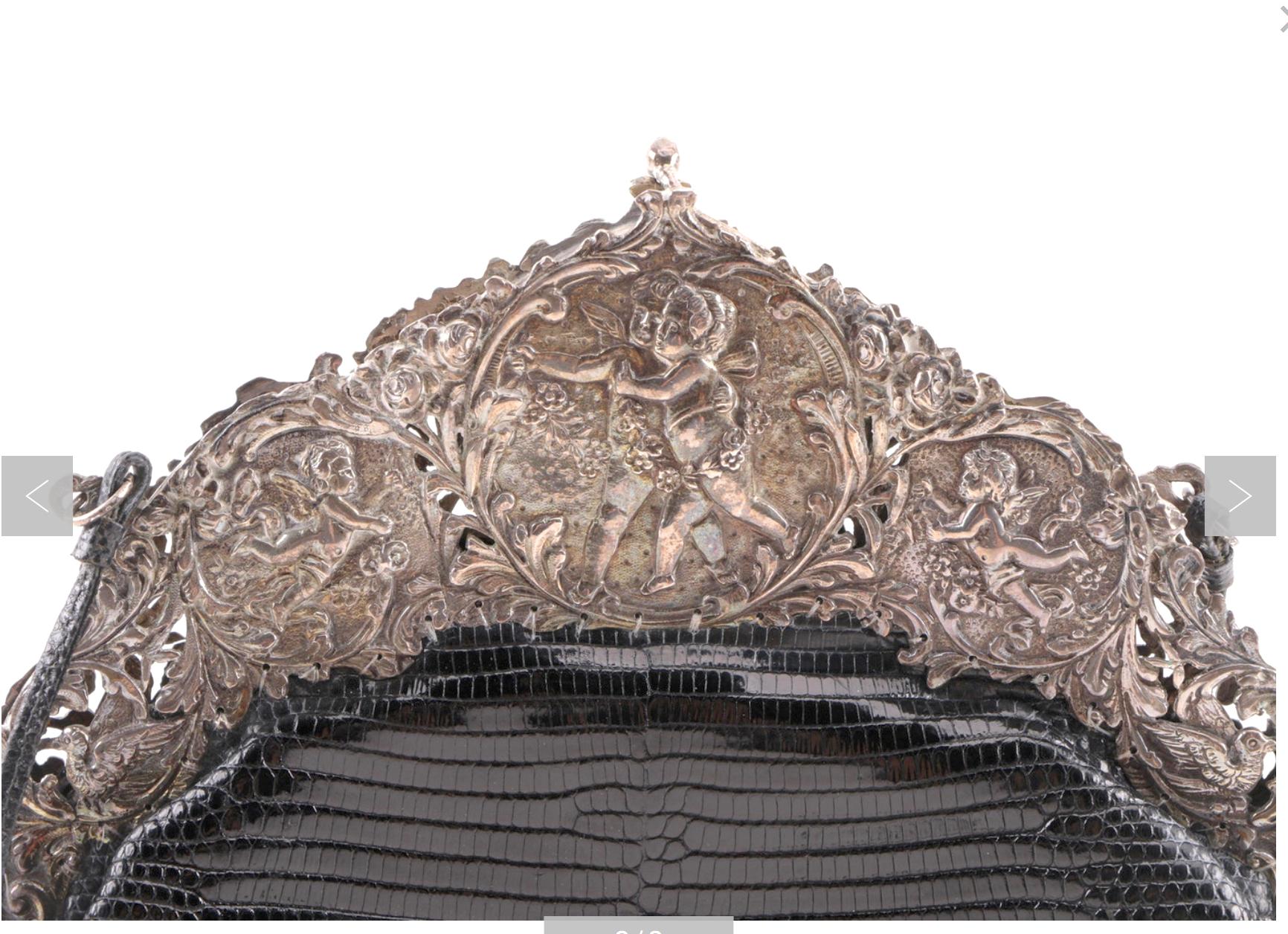 For a Fashionista-an Inspired Chic Sterling Silver 800 circa 1910 Handbag European Frame with an added 1980s Black Lizard Leather Evening Bag.
The gorgeous arched frame has a Baroque style openwork design featuring multiple putti and scroll work