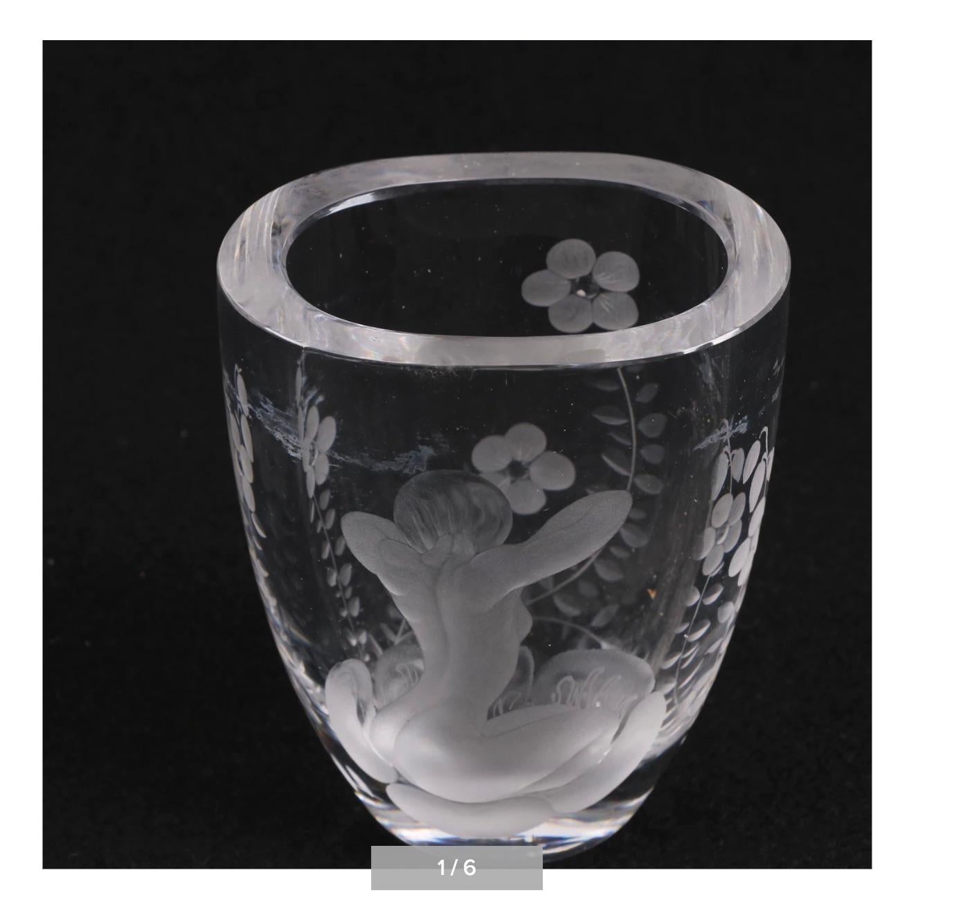 A circa 1920s sumptuous Lars Kjellander Swedish engraved glass vase. 
The substantial weighty vase features a thick, flat rim, a tapered ovoid body, and oval base. 
The piece is gorgeously embellished with floral and foliate patterns throughout, and