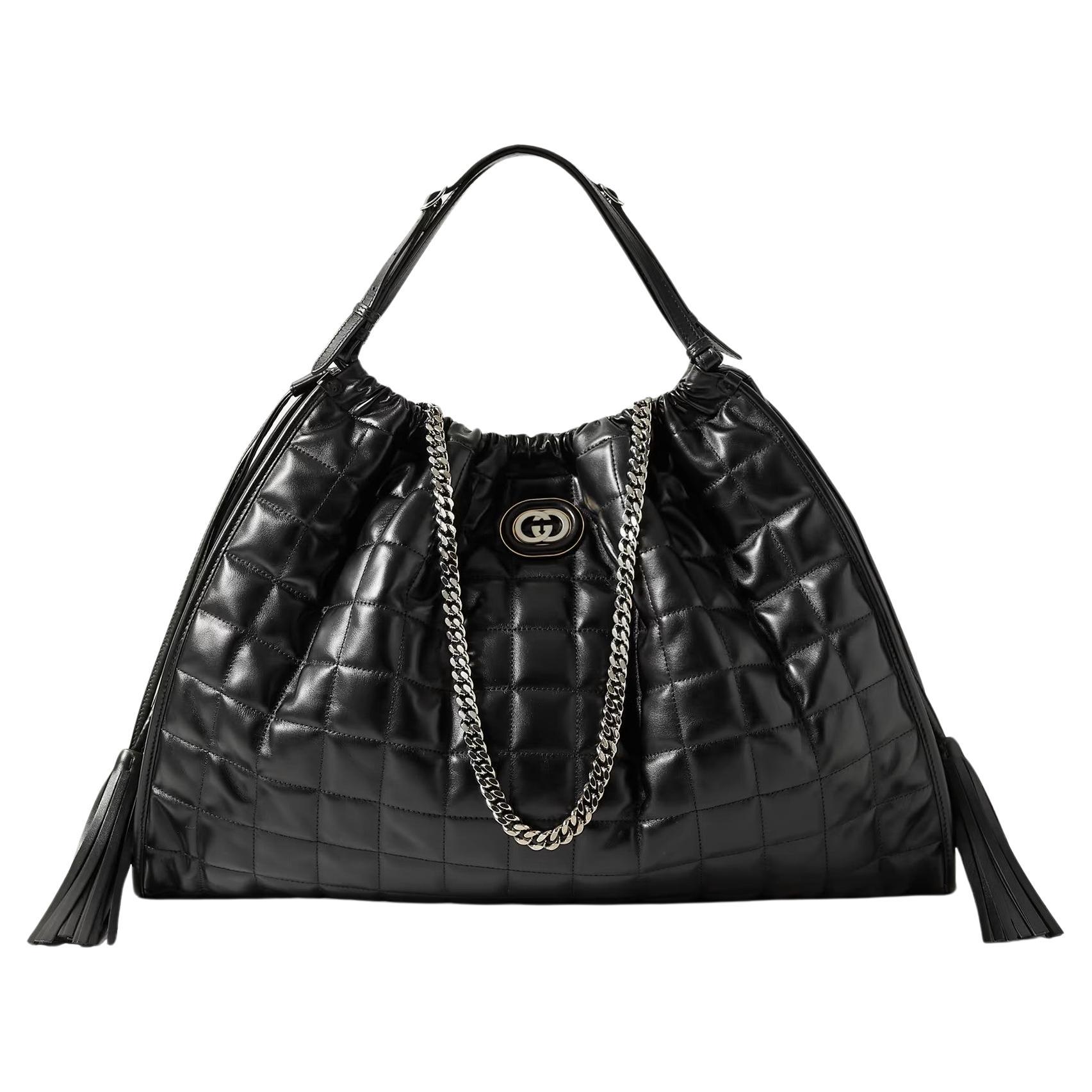 Brand New with Tags
$4980

Gucci's 'Deco' tote is made from glossy leather that's quilted for a grid-like texture. 
Designed in a large slouchy shape, it's embellished with the iconic interlocking 'G' logo and has fringed drawstrings that secure