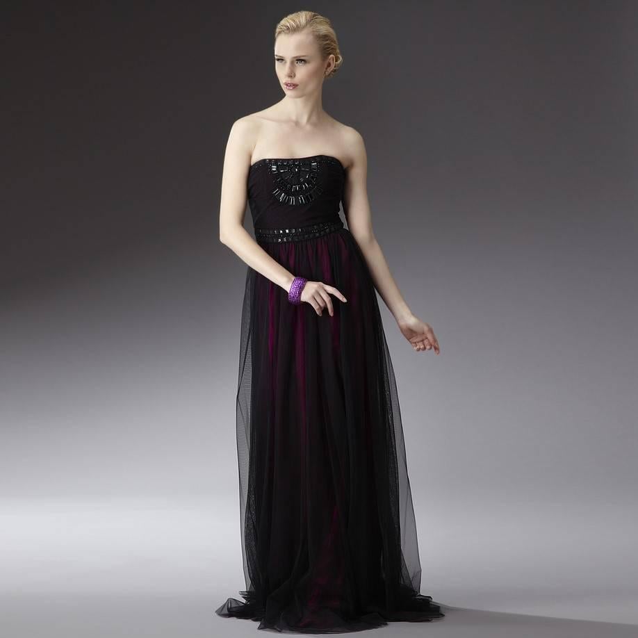 Badgley Mischka Gown
Brand New with Tags
Size: 6
100% Black Nylon Overlay
100% Silk Fuchsia Shell 
Fuchsia Silk & Black Nylon Overlay Dress
Fuchsia Silk Shell Shows Through the black Nylon for a Beautiful Color 
Zipper and Hook Closure
Beading at