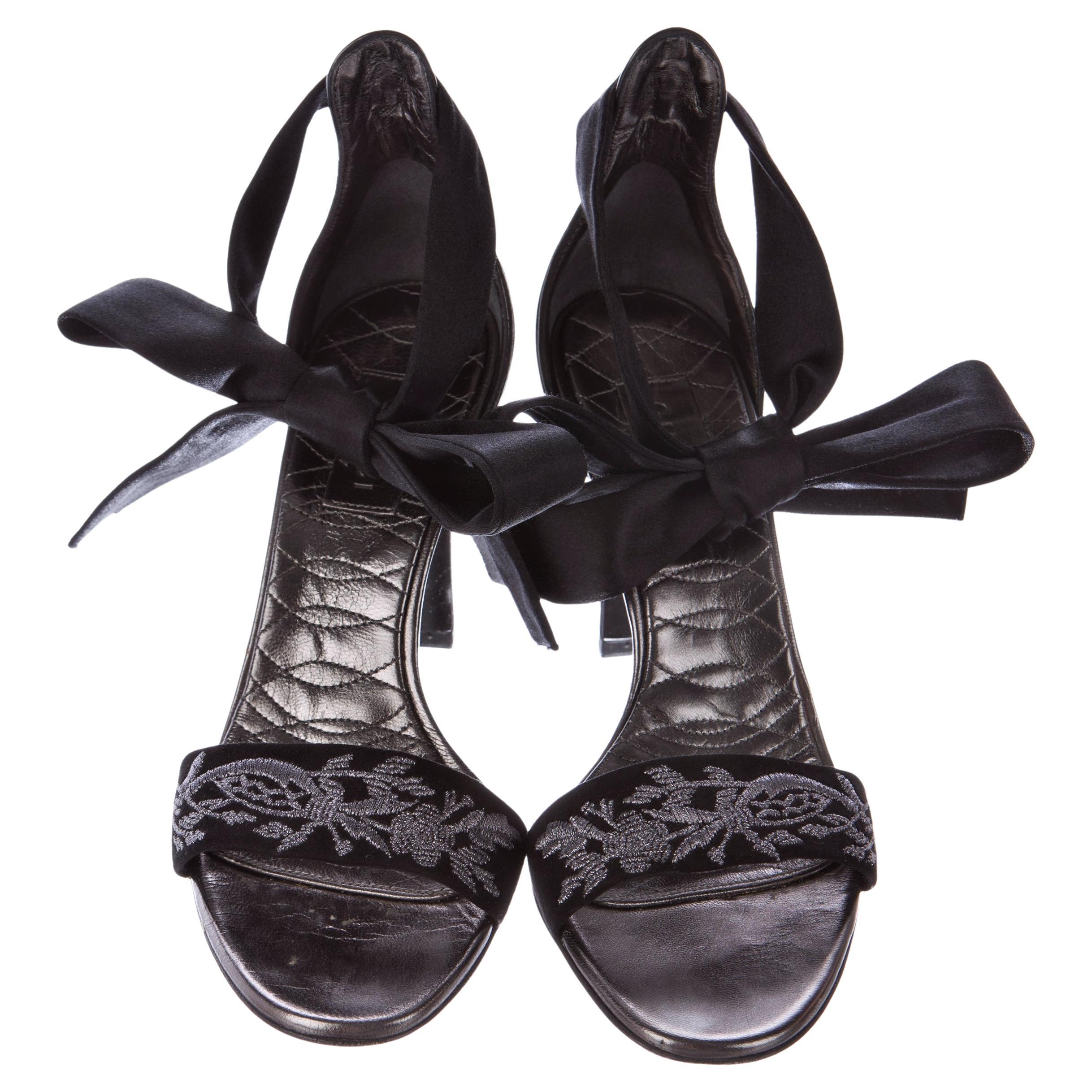 Gucci Brocade Heels
Brand New
* Size: 8.5 
* Black Suede & Silver Brocade
* Open Toe
* Satin Ankle Straps
* Metallic Quilted Soft Leather Insole
* 3.5