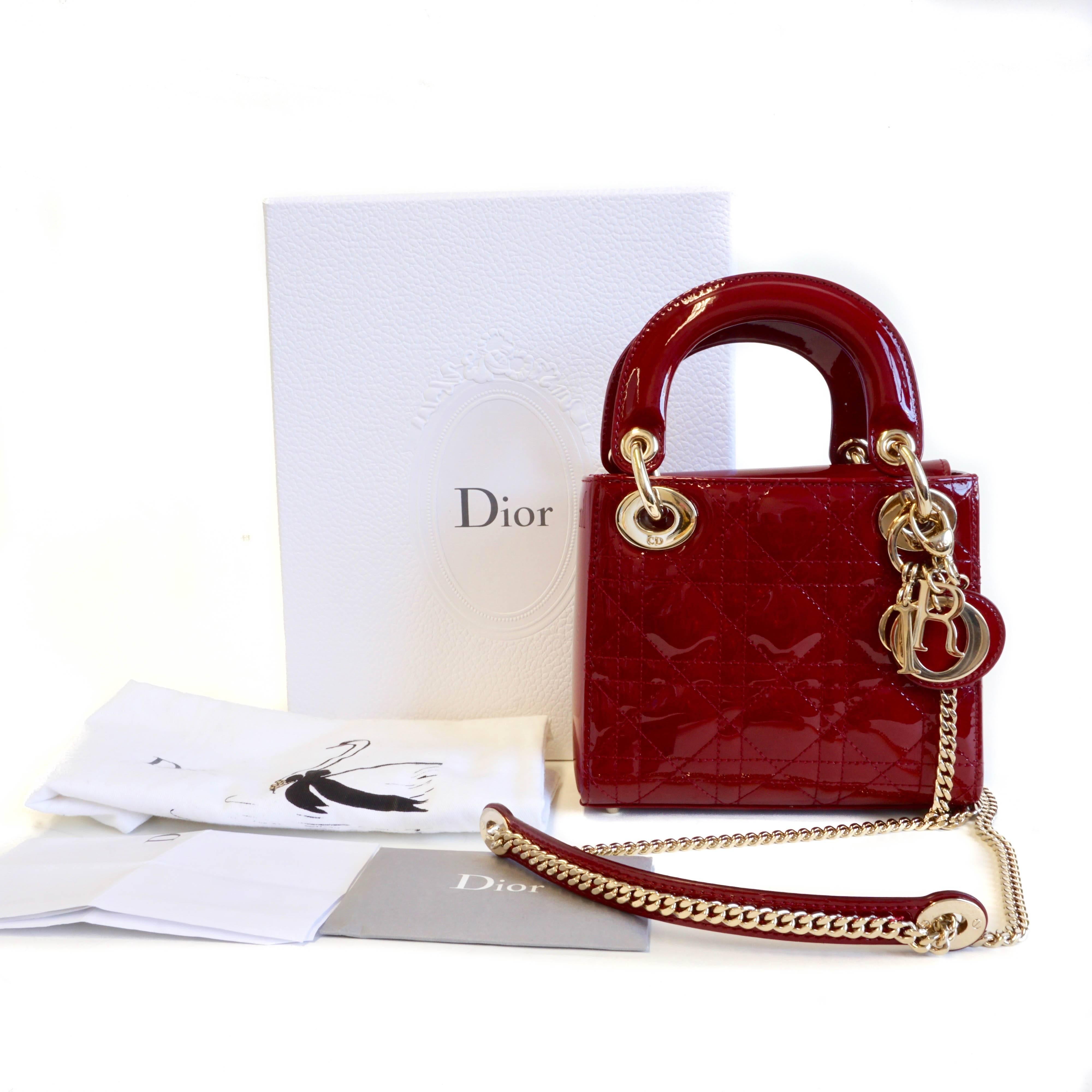 This chic mini Lady Dior handbag is so adorable. The chain strap is lengthy enough to be worn as a shoulder bag or crossbody if you don't feel like carrying it by its cute patent leather top handles. There is a structured flap over the top of the