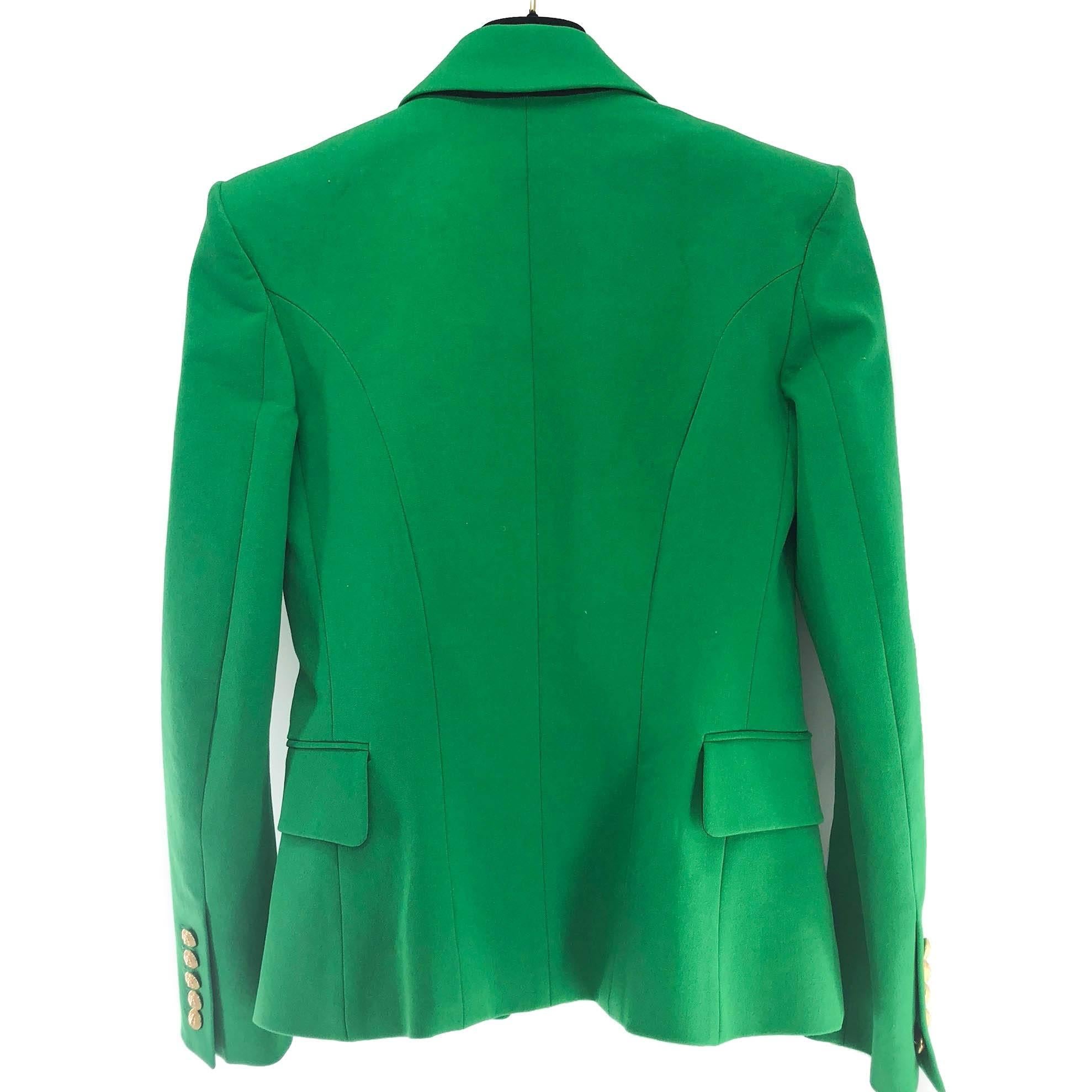 This Emerald Green Balmain Blazer in size 40 with oversized gold buttons is a gorgeous statement piece that transcends the trends. Enjoy this with a skirt, or jeans for a smart casual look.

Condition is Like New, has been altered but never worn.