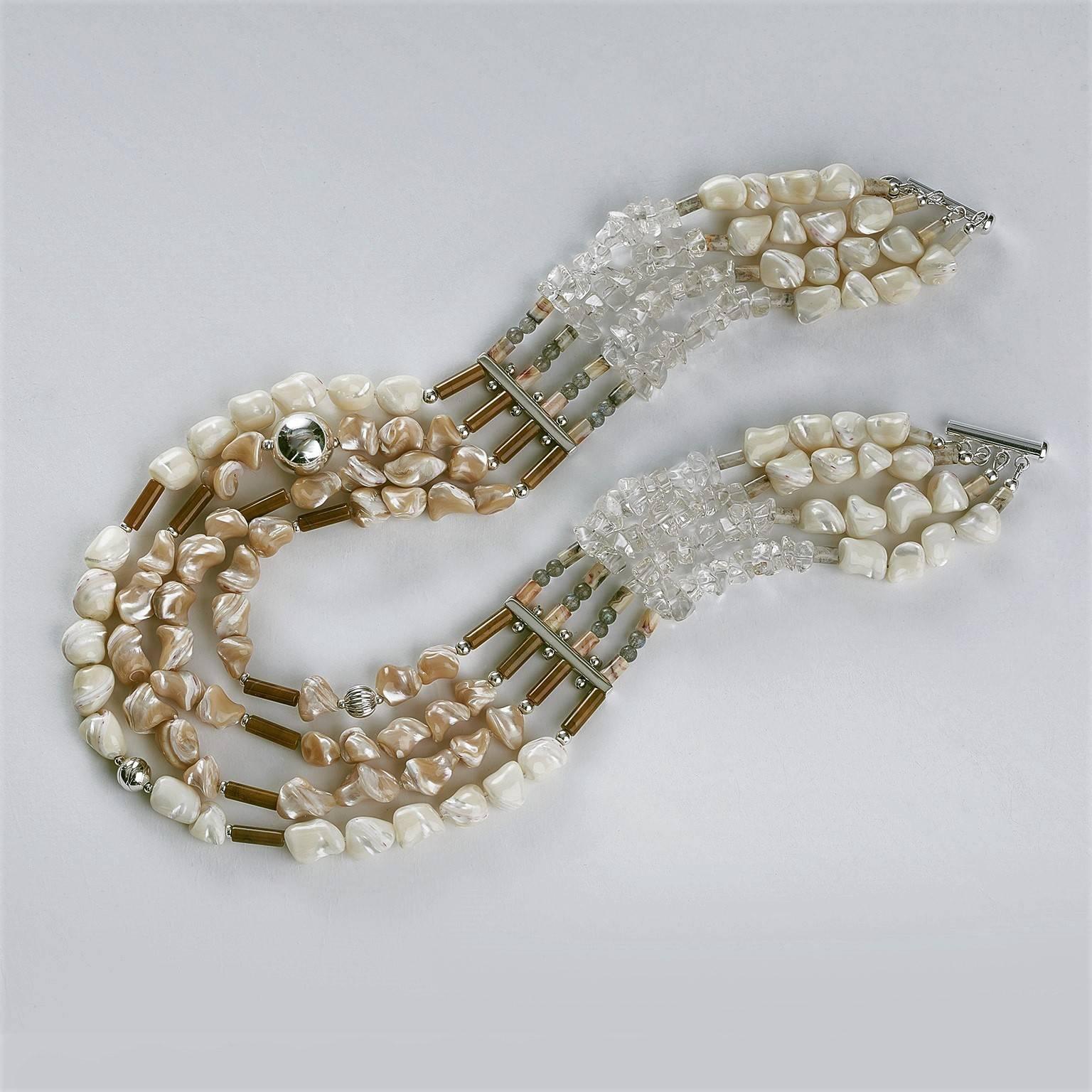 The four strand necklace composed of naturally colored, with off-white and caramel ( MOP ) mother of pearls nugget shape trochus, 18-10 mm beads and free-form crystals that contrast beautifully with the dark onyx and agate tubes, accented delicately