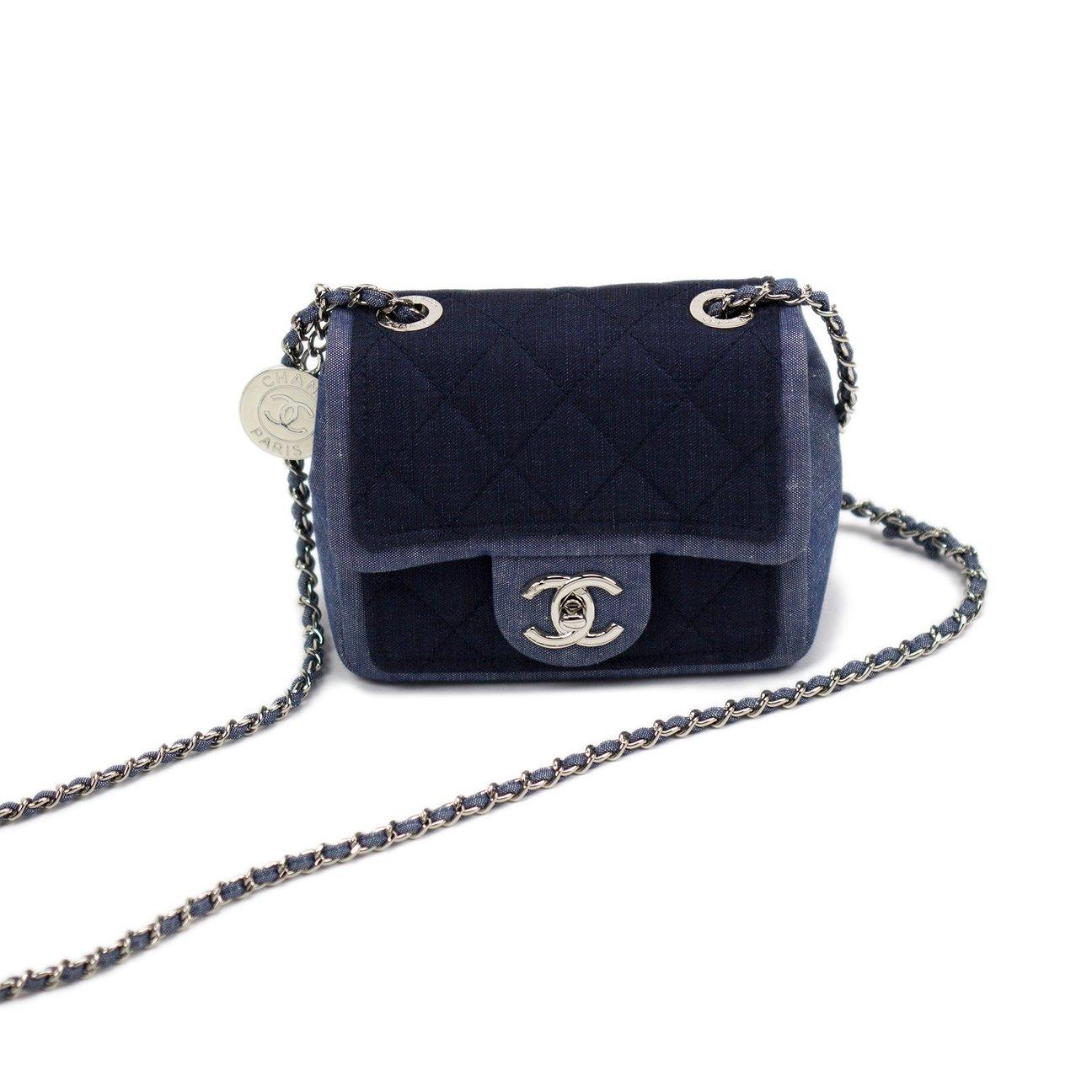 Small denim jean two tone Chanel medallion mini crossbody shoulder classic flap

Year: 2014
Interwoven classic chain with metal CC coin detail
Silver hardware
Denim lined interior
Interior center pocket
Additional front pocket
Dimensions: 5.25