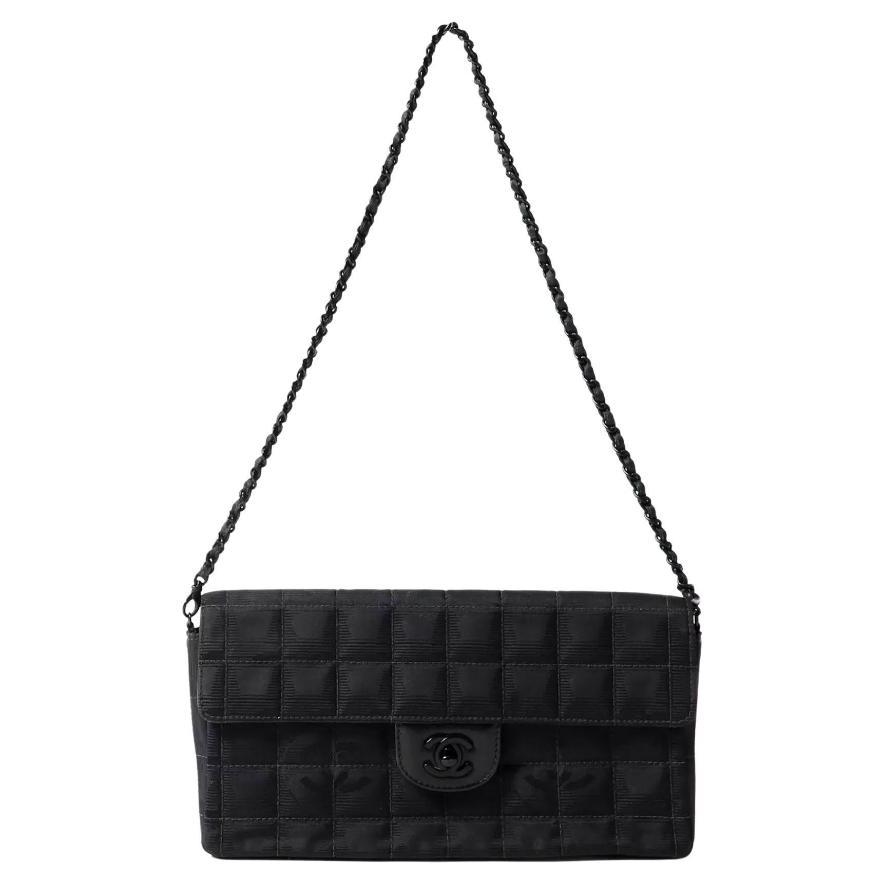 Chanel Vintage So Black Long Medium Shoulder Bag

Year 2002 {Vintage 22 Years}

Black nylon canvas with a flap top 
CC turn-lock closure 
Leather entwined chain shoulder strap 
Black metal hardware 
Carry it as a clutch or shoulder bag 
Interior has