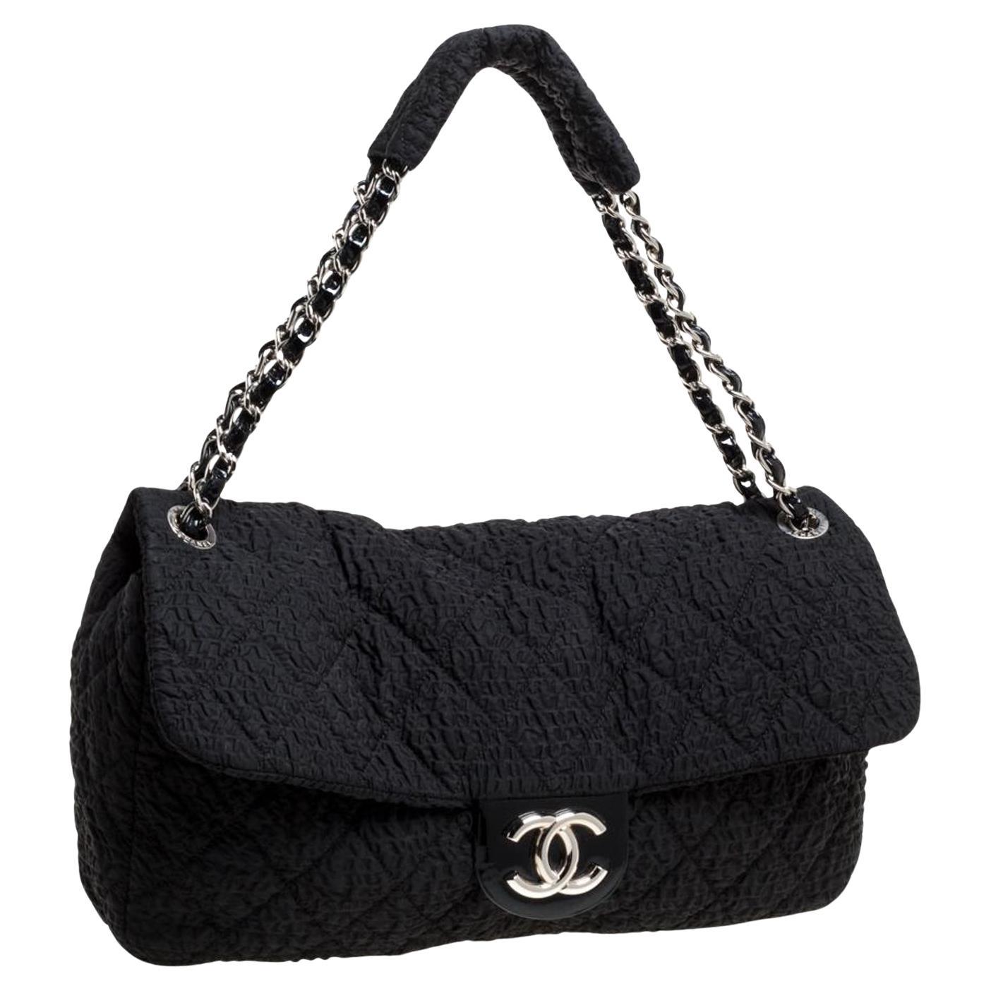 Chanel large plush Chanel textured flap with patent leather detail

Year: 2010
Silver hardware
Magnetic clasp closure
Interior grey microfiber lining
Center zippered pocket
Patent leather interwoven chain with shoulder padding detail
Strap drop: