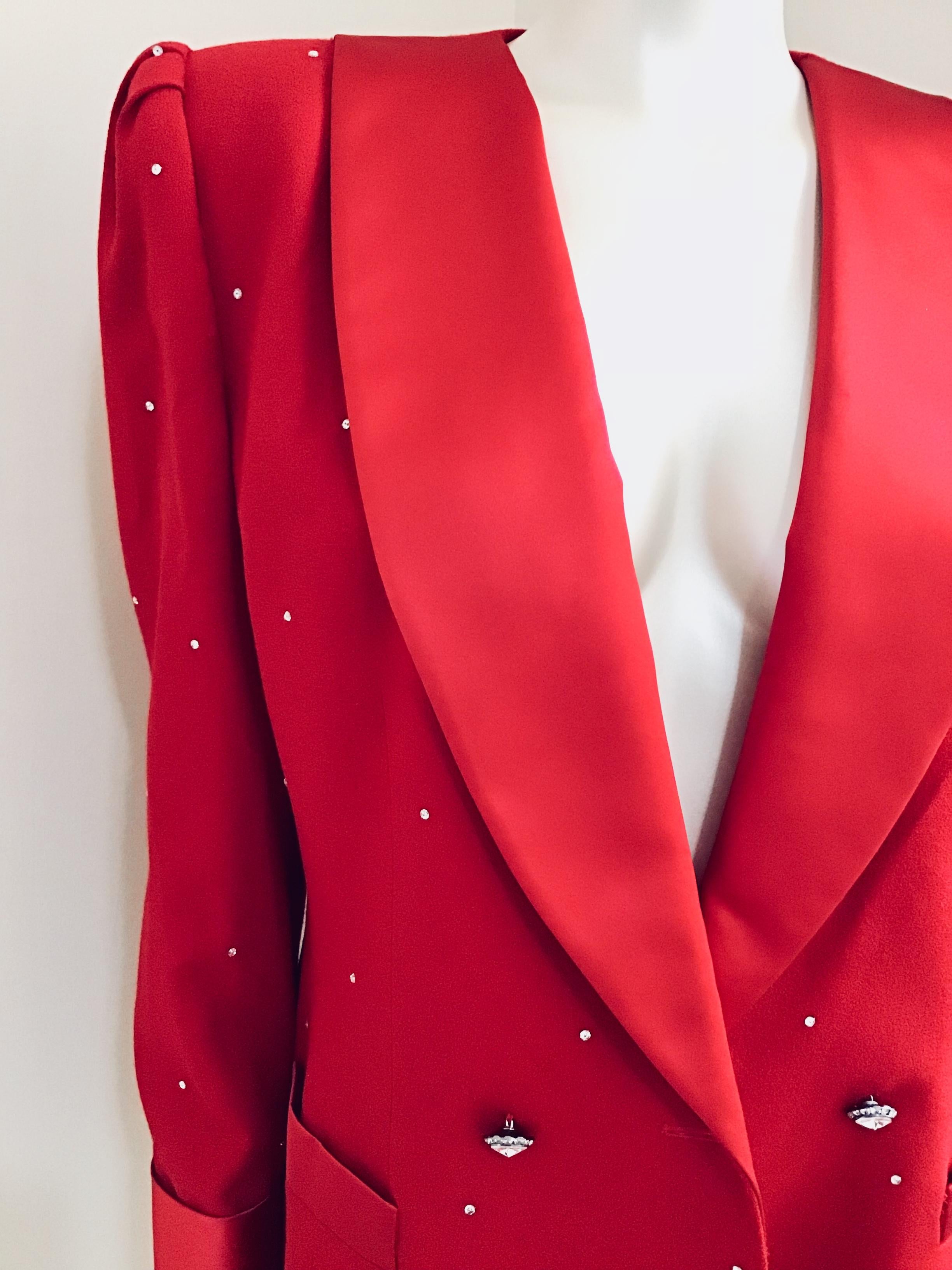 The perfect color red with accents of satin combined with crystal buttons creates the perfect late night blazer. It can easily be worn with dark denim skinny jeans and red bottoms or a satin pencil pant. Either look and you are sure to stand out!
