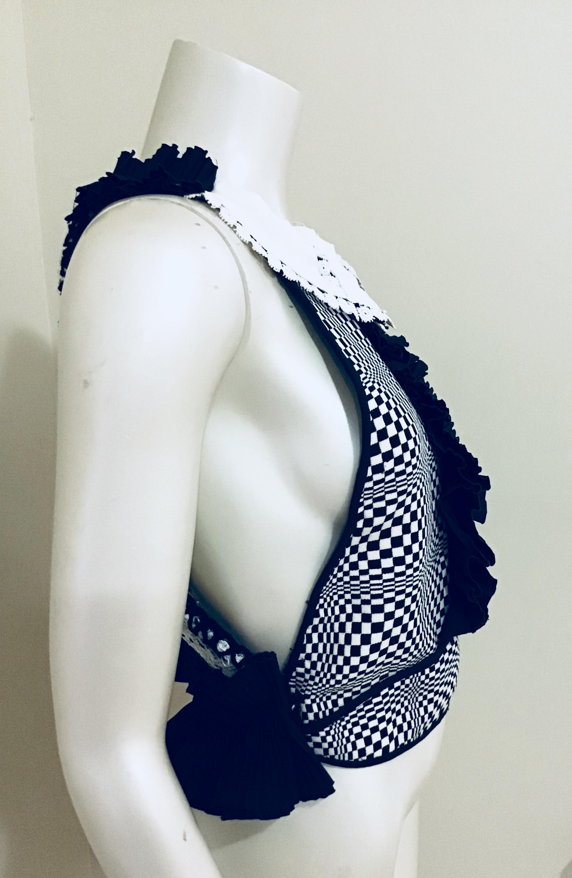 This Black & White vintage fabric combined with a 40s cuff as its collar, and its open knit back together create this couture cutie. The black ruffle center adds flare to an already unique piece. Wear this one of a kind top with jeans at Saturday
