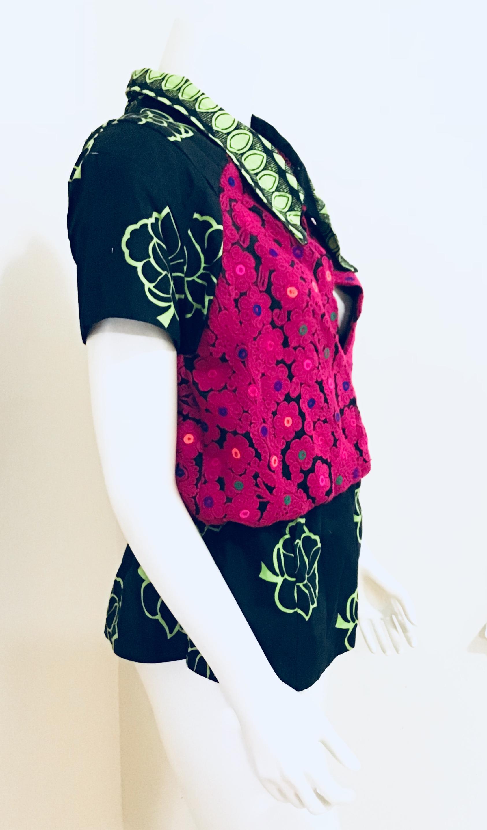 Two cultures collide with this plunging neckline pullover. It’s black and maroon textured body blends perfectly with the black and green ethnic print to create this sexy and colorful top. It’s elastic waist cinches to provide a added faux peplum