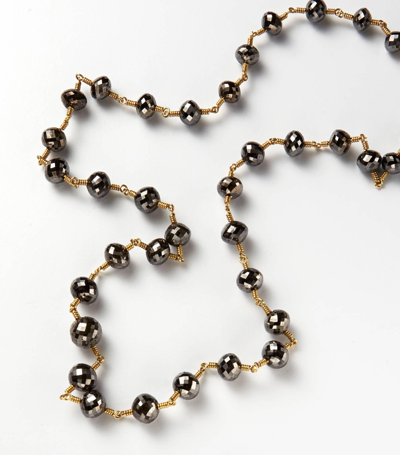 Black diamond faceted bead necklace. Diamond weight 43.80 carats. AAA Quality diamonds. Approximate size of diamonds is from 6mm to 5 mm. 18K Gold. Length of necklace 18 inches.