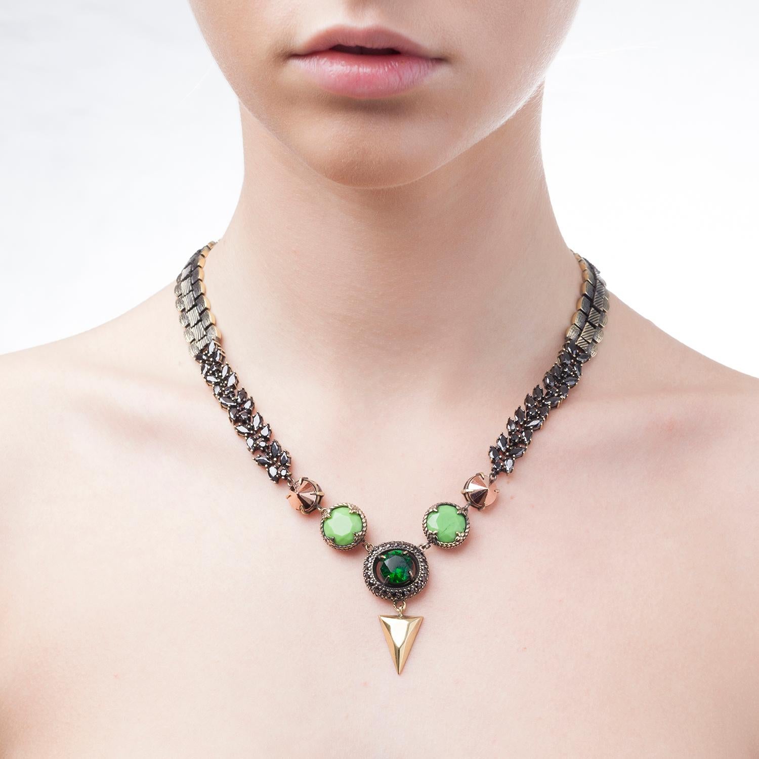 It's all about Iosselliani love for mixing details and materials for this chain necklace. Enriched with two sided of jet zircons flur chain, the necklace from Iosselliani features a 10K rose gold plated brass chain, green glass round stones. A green