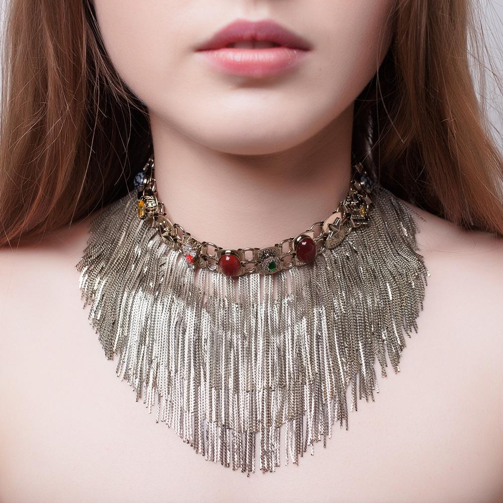 This unique statement necklace is designed to blend a harmonious balance between elegance and extra impact. The custom made chain choker is dotted with small cabochon in agate and obsidian and features multiple strands of fringes to bring dynamics